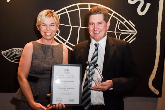 <p>Bryan Mason, Churches of Christ Care director of seniors and supported living, accepts the Organisation Award from Perform HR chief executive, Lyndell Fogarty.</p>