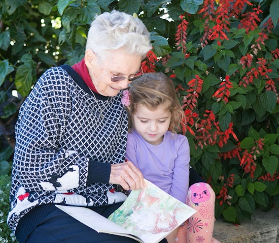 <p>Wesley Mission Brisbane aged care resident, Joan, and Lily, from the Wheller Gardens on-site Little Marchants Child Care Centre, enjoy reading together.</p>
