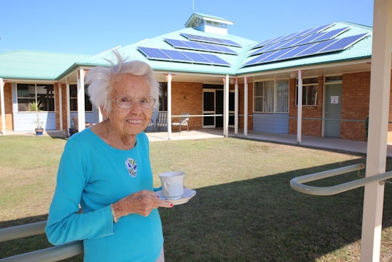 <p>Resident Beattie Clark enjoying a cup of tea made from hot water heated by the new solar panels.</p>
