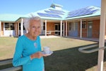 Resident Beattie Clark enjoying a cup of tea made from hot water heated by the new solar panels.