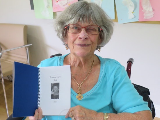 <p>Mrs Snow with the poems dedicated to her grandchildren.</p>
