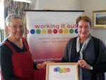 Uniting AgeWell&#146;s Strathdevon Manager Integrated Services Vicki Pollock (right) receiving the award from Susan Ditter, the Executive Officer of award organisers Working It Out.