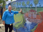 Ms Stevenson with a mural she organised at the hostel