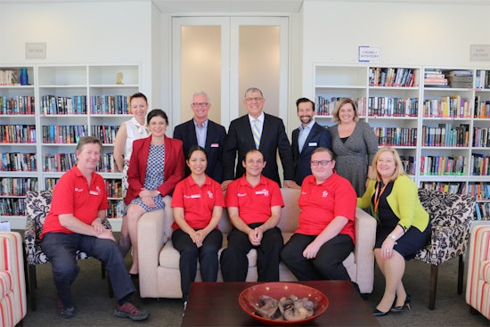 <p>IRT Group CEO Nieves Murray (on arm of chair), Flagstaff Group CEO Roy Rogers, The Hon John Akaka MLA and CareerAbility in Aged Care Program participants with IRT College employees</p>
