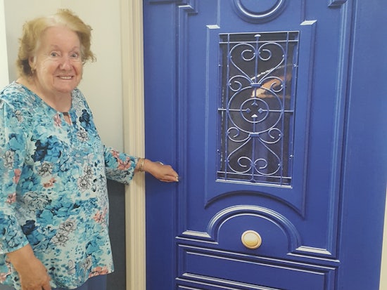 <p>Bethanie resident Elizabeth Bowron standing in front of her new door (Source: Bethanie)</p>
