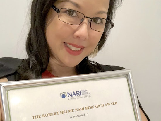 <p>winning researcher Dr Anita Goh with her award (Source: Twitter)</p>
