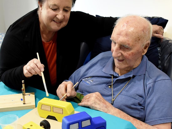 <p>90-year-old Colin James and his daughter Kaye painting presents to donate to the Salvation Army (Source: Resthaven)</p>
