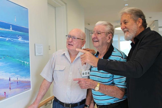 <p>Newcastle artist Paul Andrews (right) with Kilpatrick Court day program participants Ken Tredennick and Bob Crowe reminisce old times spent at Newcastle Beach</p>
