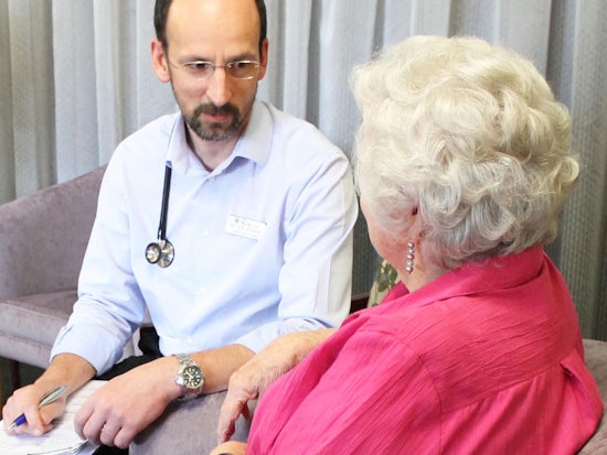 <p>Specilaist palliative care nurse practitioner Peter Jenkin with a patient</p>
