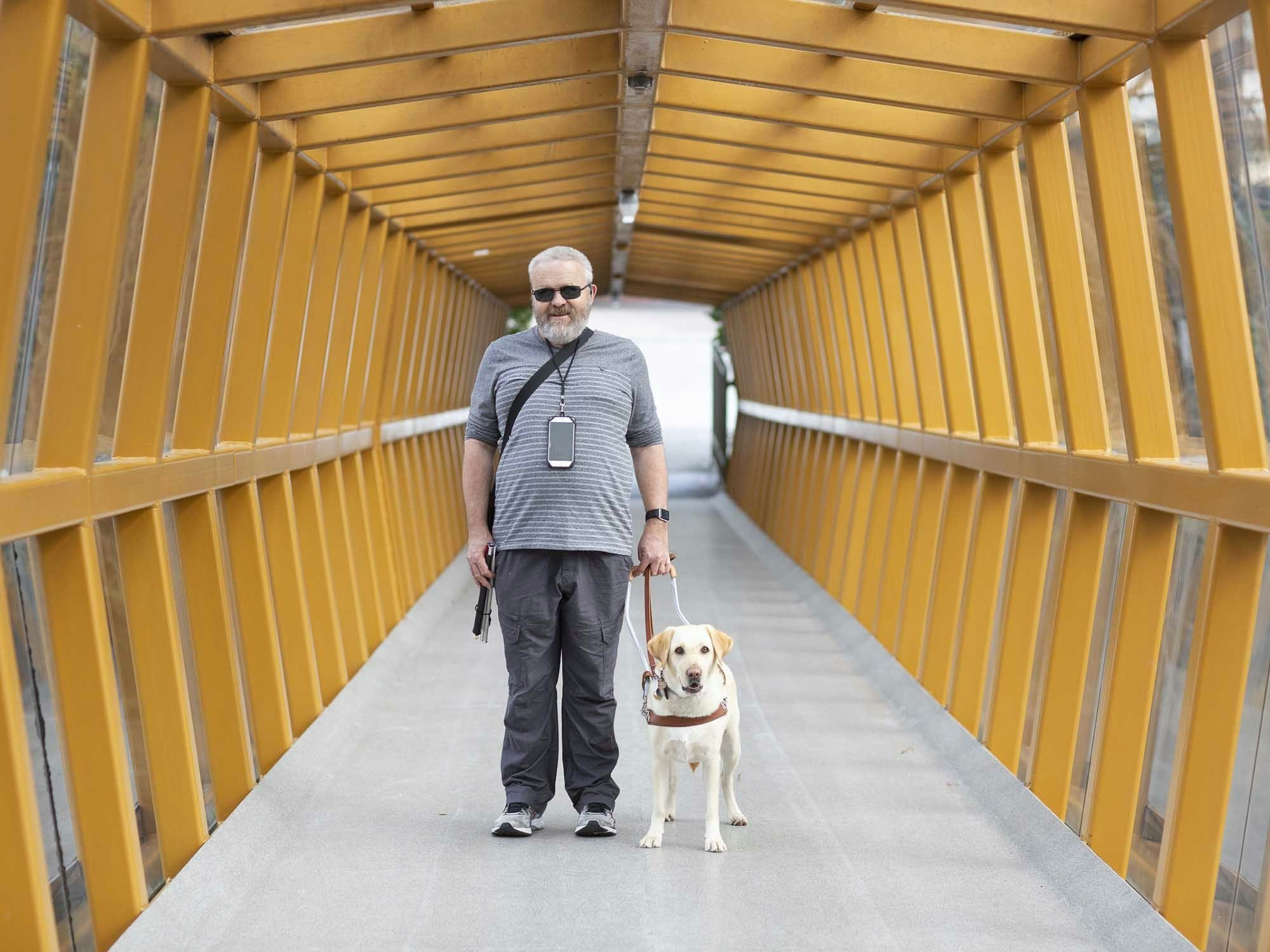 Vision Australia’s Access Technology Advisor David Woodbridge has been using Soundscape with his assistance dog [Source: Vision Australia]

