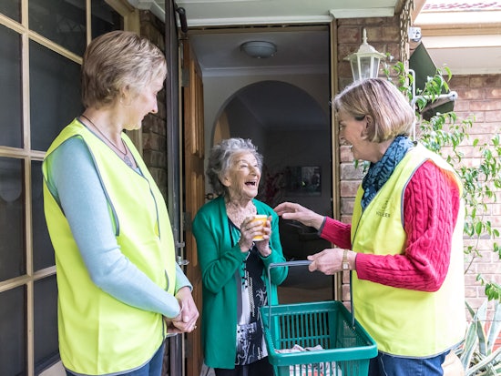<p>Meals on Wheels volunteers delivering a delicious meal to a client (Source: Meals on Wheels Australia)</p>
