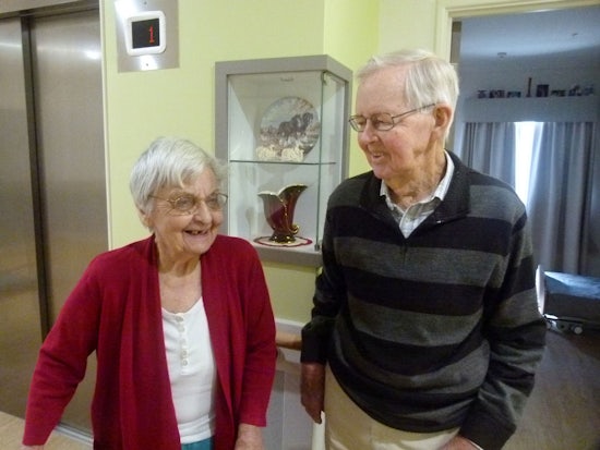 <p>Gwen and Bill Moore in front of Ms Moore’s memory box featuring items special to her</p>
