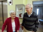 Gwen and Bill Moore in front of Ms Moore's memory box featuring items special to her