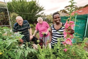 <p>Resthaven volunteer Florence Eremugo with residents Ted and Dulcie Collins – Supplied by Resthaven</p>
