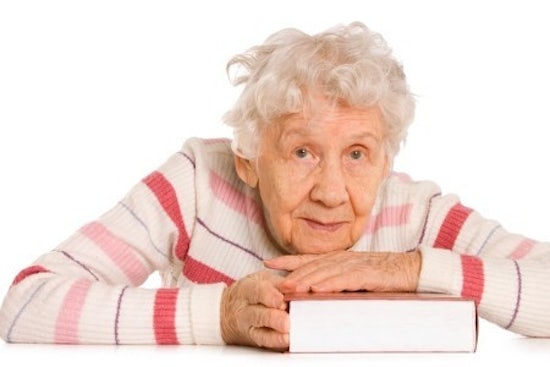 <p>Old woman leaning on book</p>
