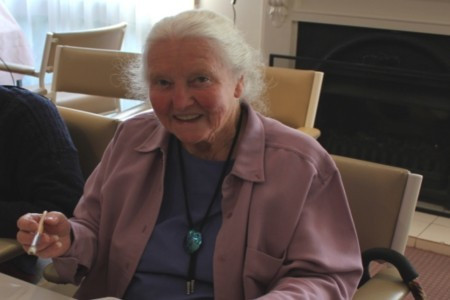 <p>Kathleen Edwards sits holding paintbrush</p>
