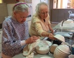 Palm Court residents get their daily functional exercise by washing dishes, as part of the Alzheimer's Queensland's falls prevention program.