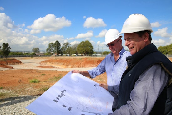 <p>Mike Bosel, PresCare chief operating officer, (front), and Wayne Knapp, general manager, internal relations, inspects the $100 million retirement living development plans.</p>
