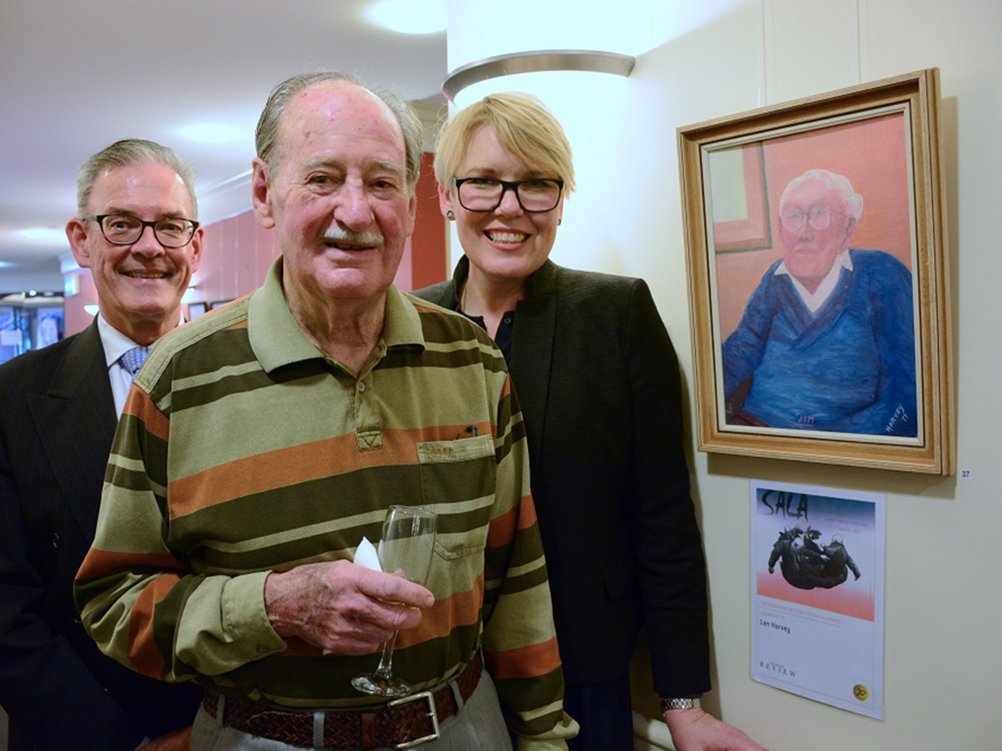 <p>Helping Hand CFO and Director of Care Environments with resident Len and his award-winning portrait (Source: Shutterstock)</p>
