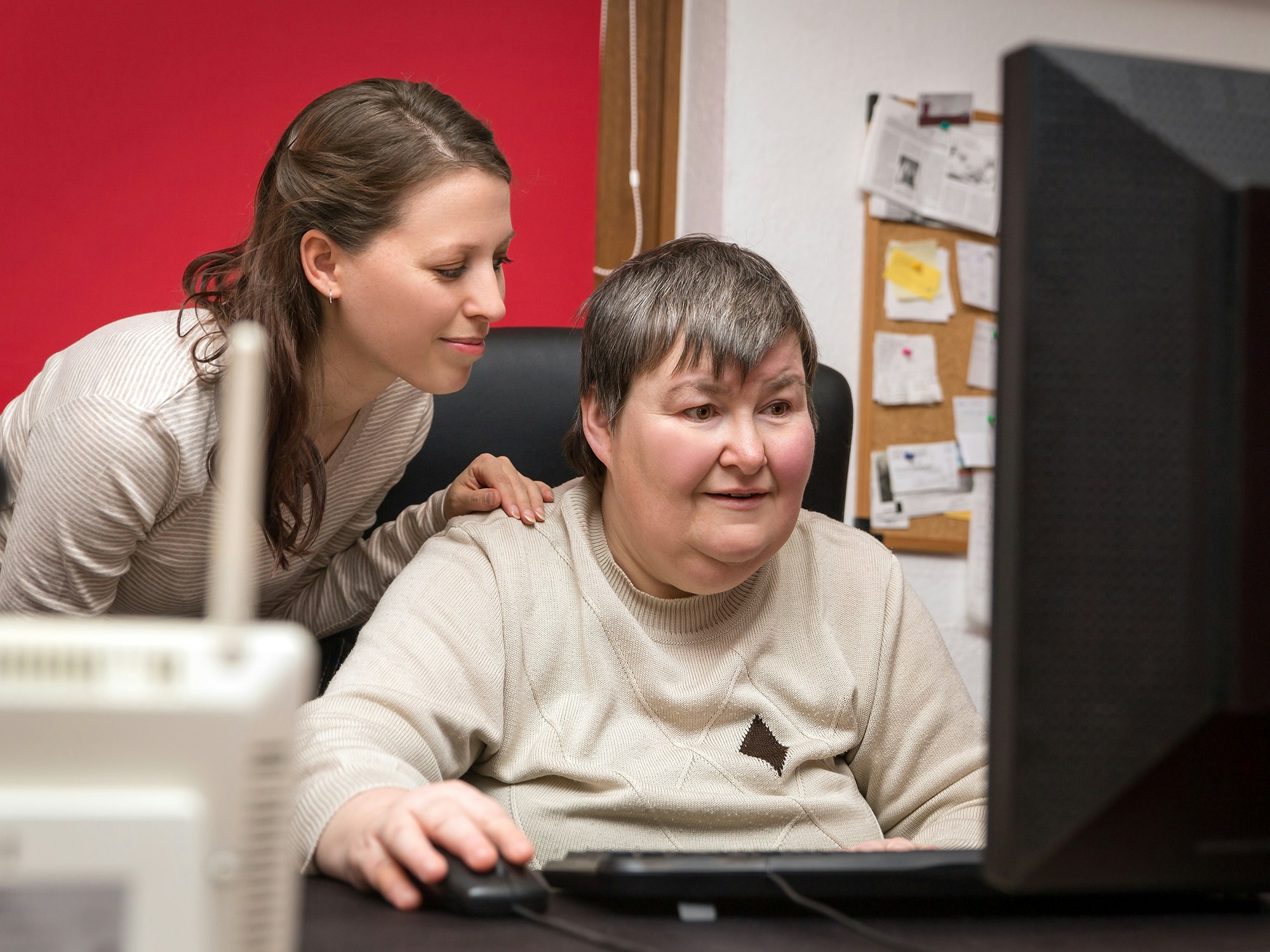 <p>Caregiver and mentally disabled woman learning at the computer. (Shutterstock)</p>
