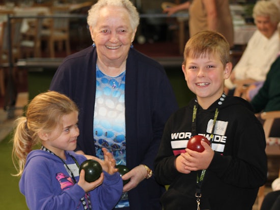 <p>Resident Ila Kalnins and students Tatum and Lockie try their hand at lawn bowling (Source: ACH Group)</p>