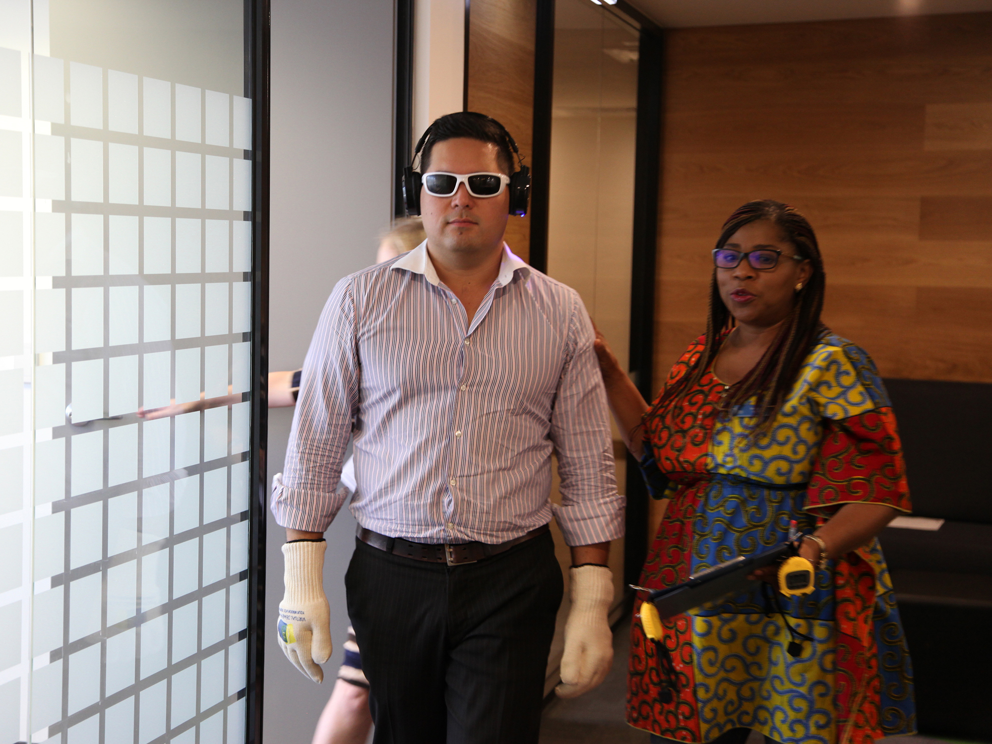 <p>Paynter Dixon employee being led by Churches of Christ Care Virtual Dementia Tour facilitator, Modupe Akib (Source: Churches of Christ)</p>
