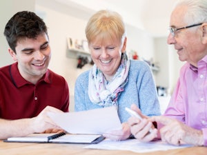 Older parents organising important documents with their son