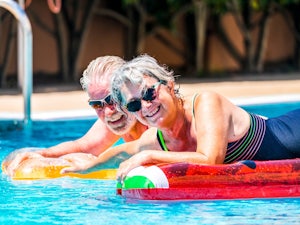 Couple relaxing in their retirement village pool