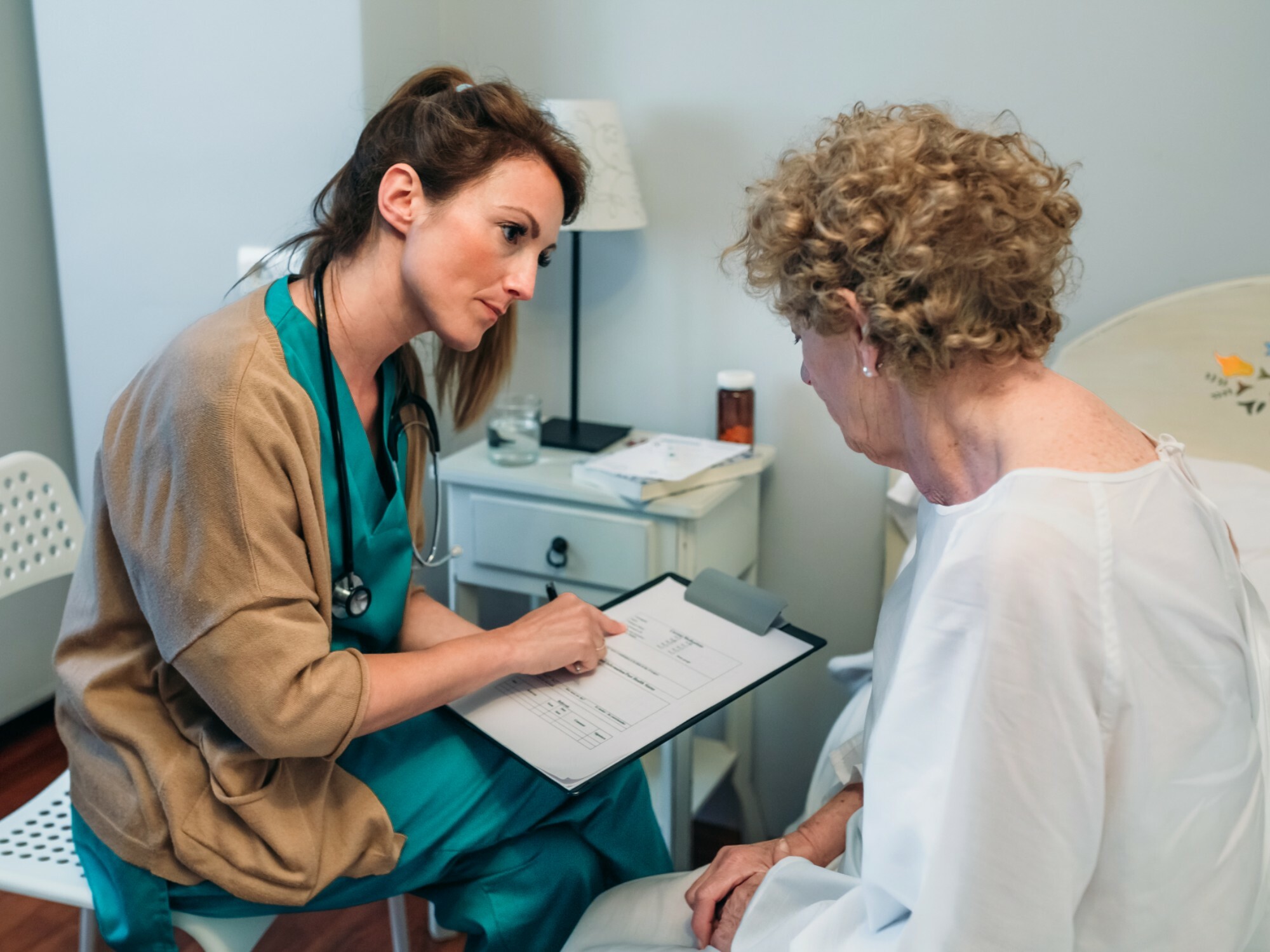 Older woman discussing their nursing home care plan