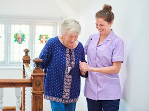Older woman receiving help from her carer
