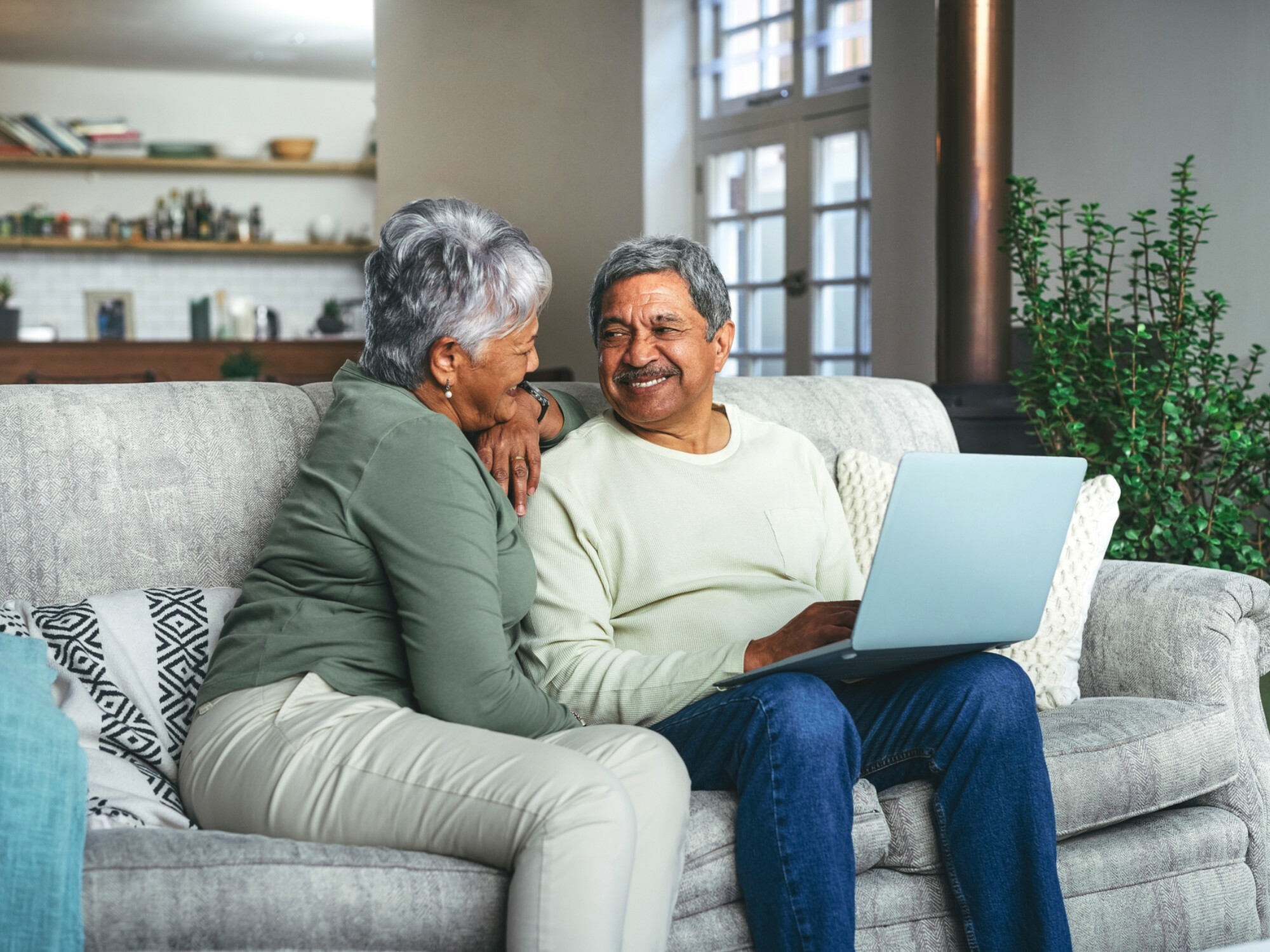 Older couple using their laptop to search for an aged care home