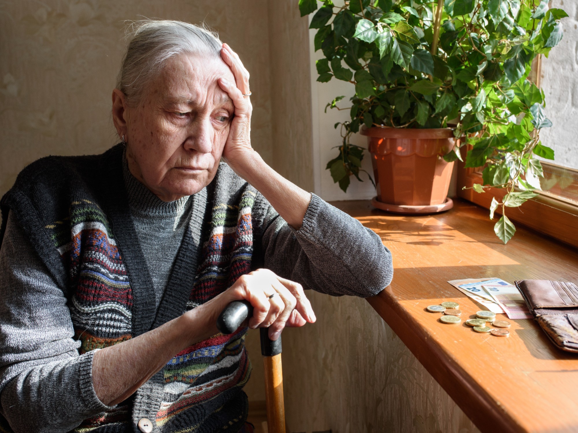 Older woman concerned over money.