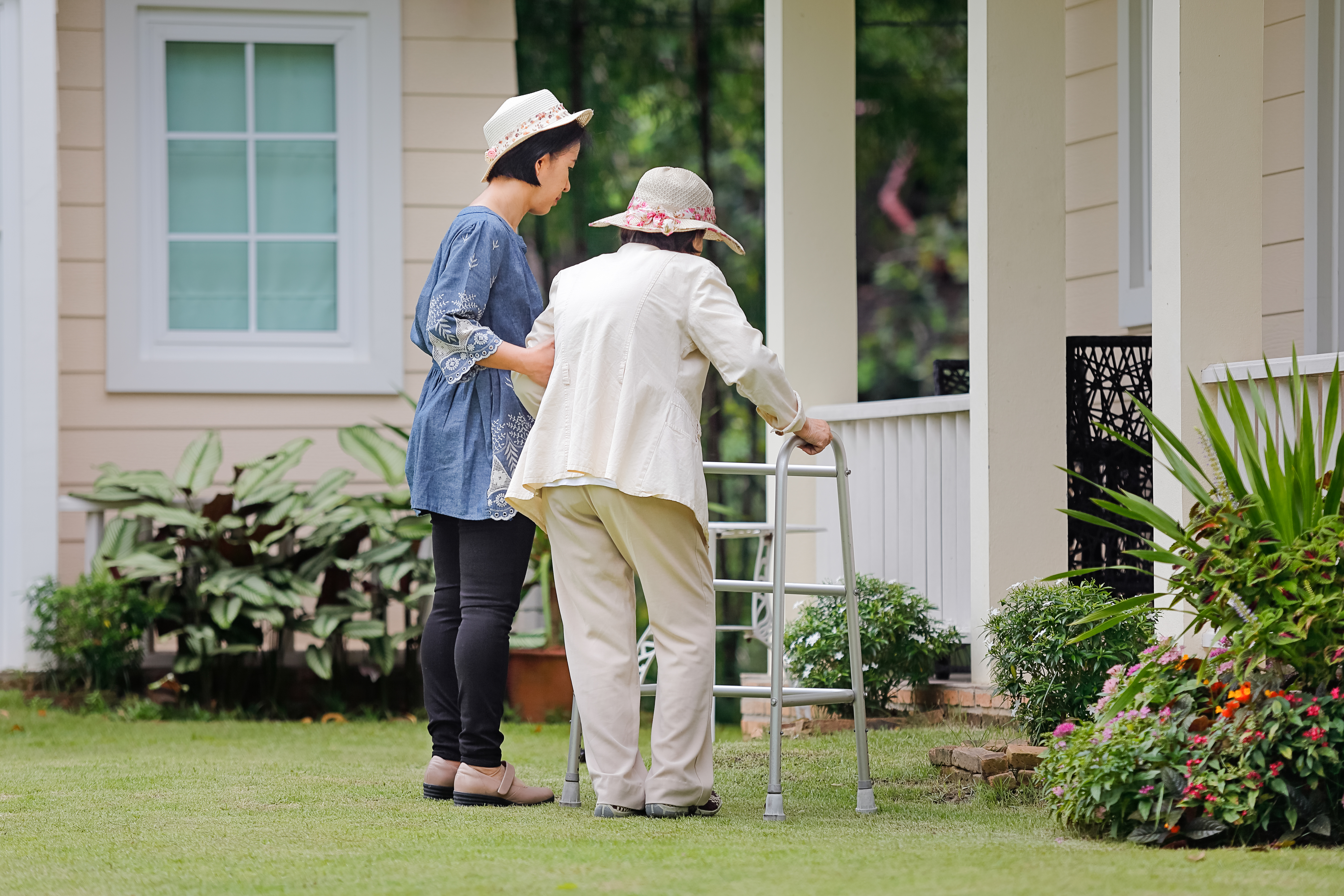 Assisting elderly lady with walking frame