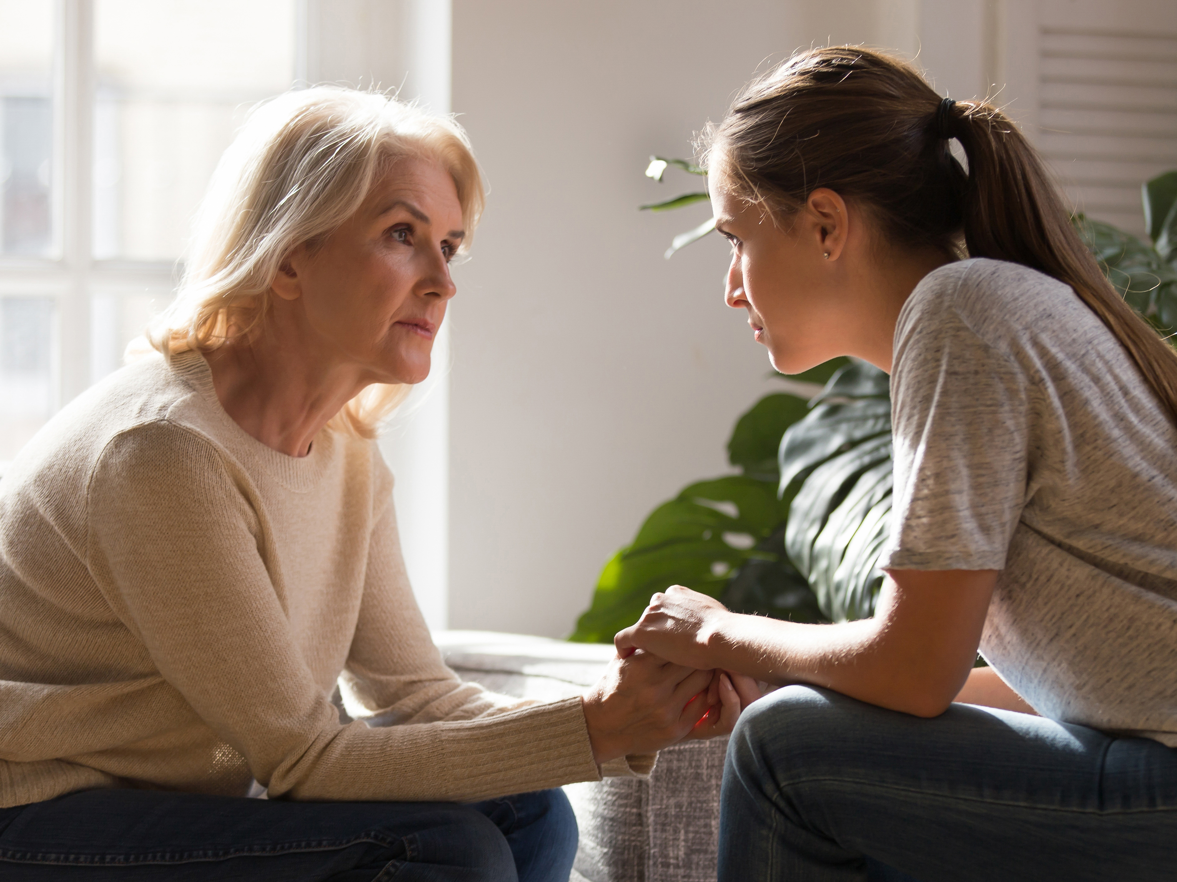 Older woman and daughter having a serious discussion.