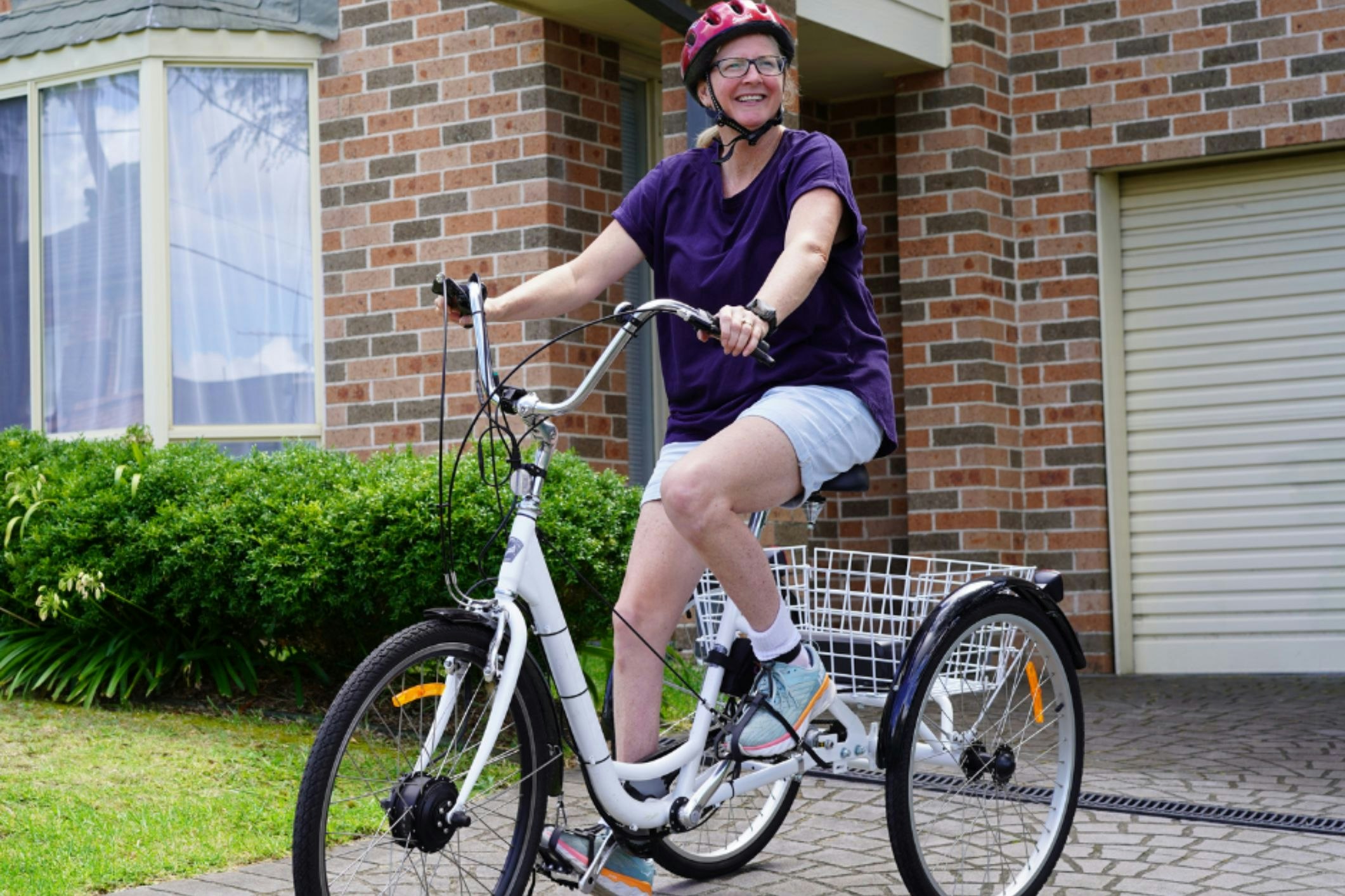 Nicole [pictured], a Solve-TAD/Freedom Solutions Australia client, is able to get around using the bespoke Freedom Wheels bike, provided by the not-for-profit organisation. [Image courtesy of Freedom Solutions Australia]
