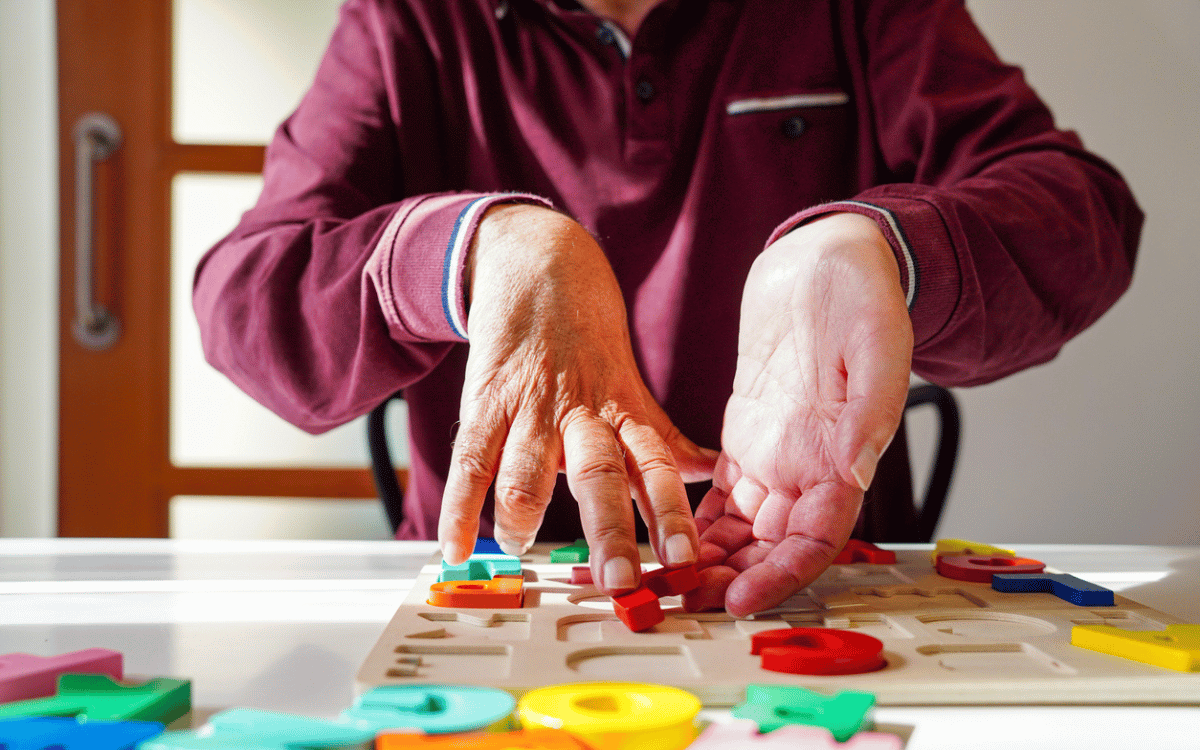 A person pushing an alphabet puzzle around