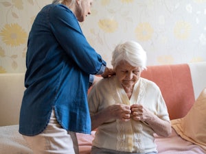 Older woman receives help at home from a carer