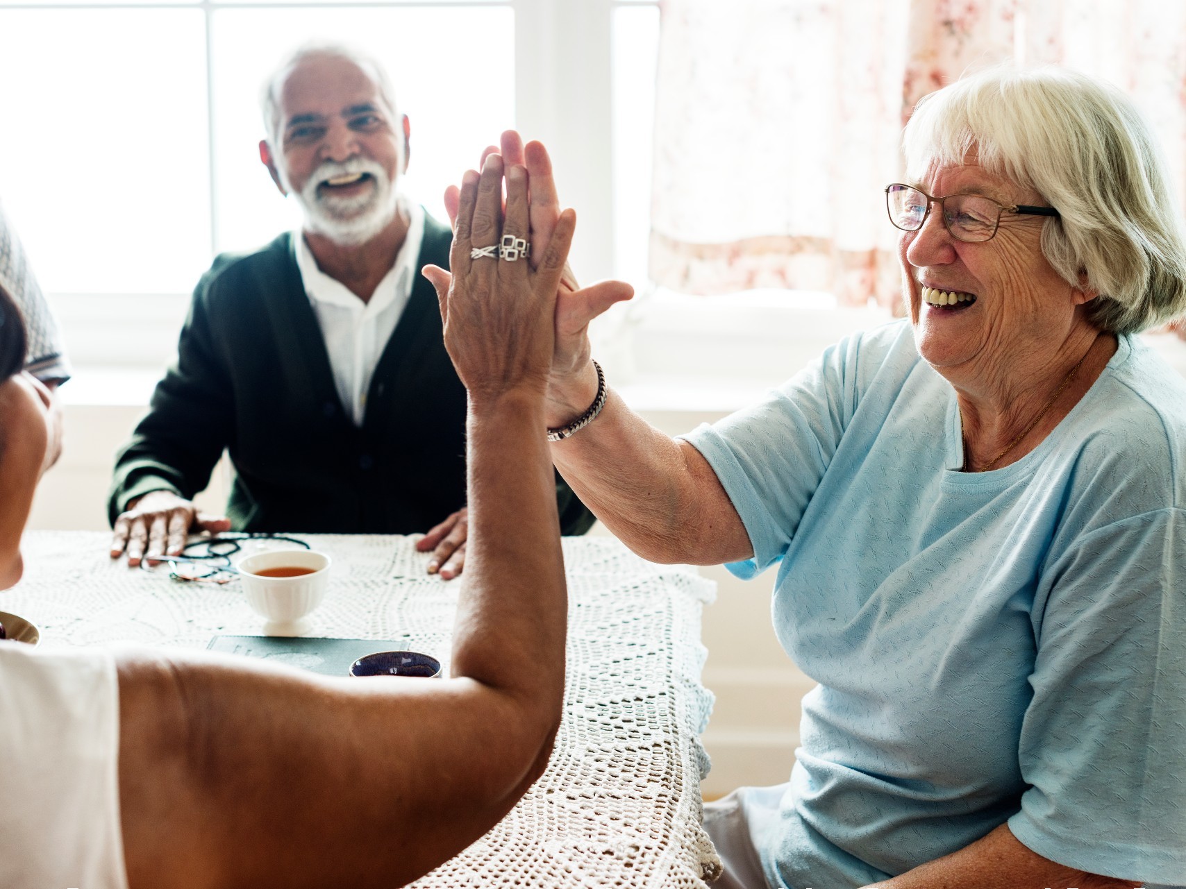 Two older people enjoying themselves with a carer