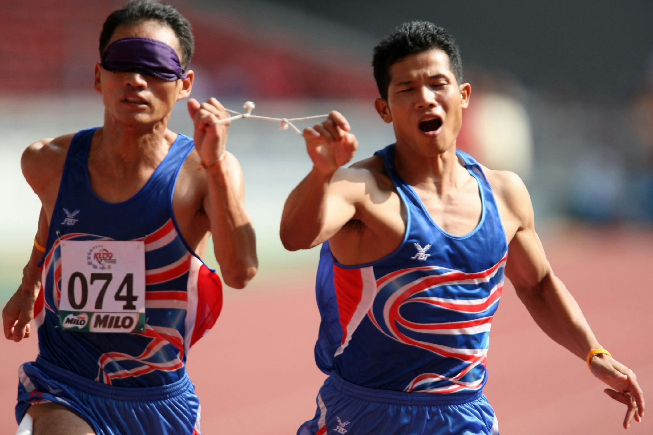 Paralympians living with vision impairment have to keep pace with their guides in an impressive show of camaraderie and determination. [Image courtesy of Chen HW via Shutterstock]
