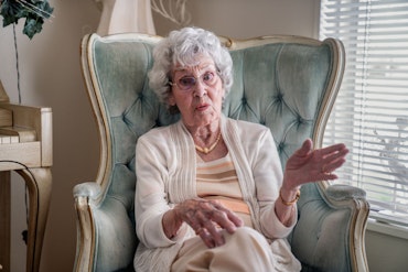 A grandmother sitting in a chair.