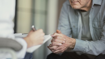 Doctor talks with patient and takes notes