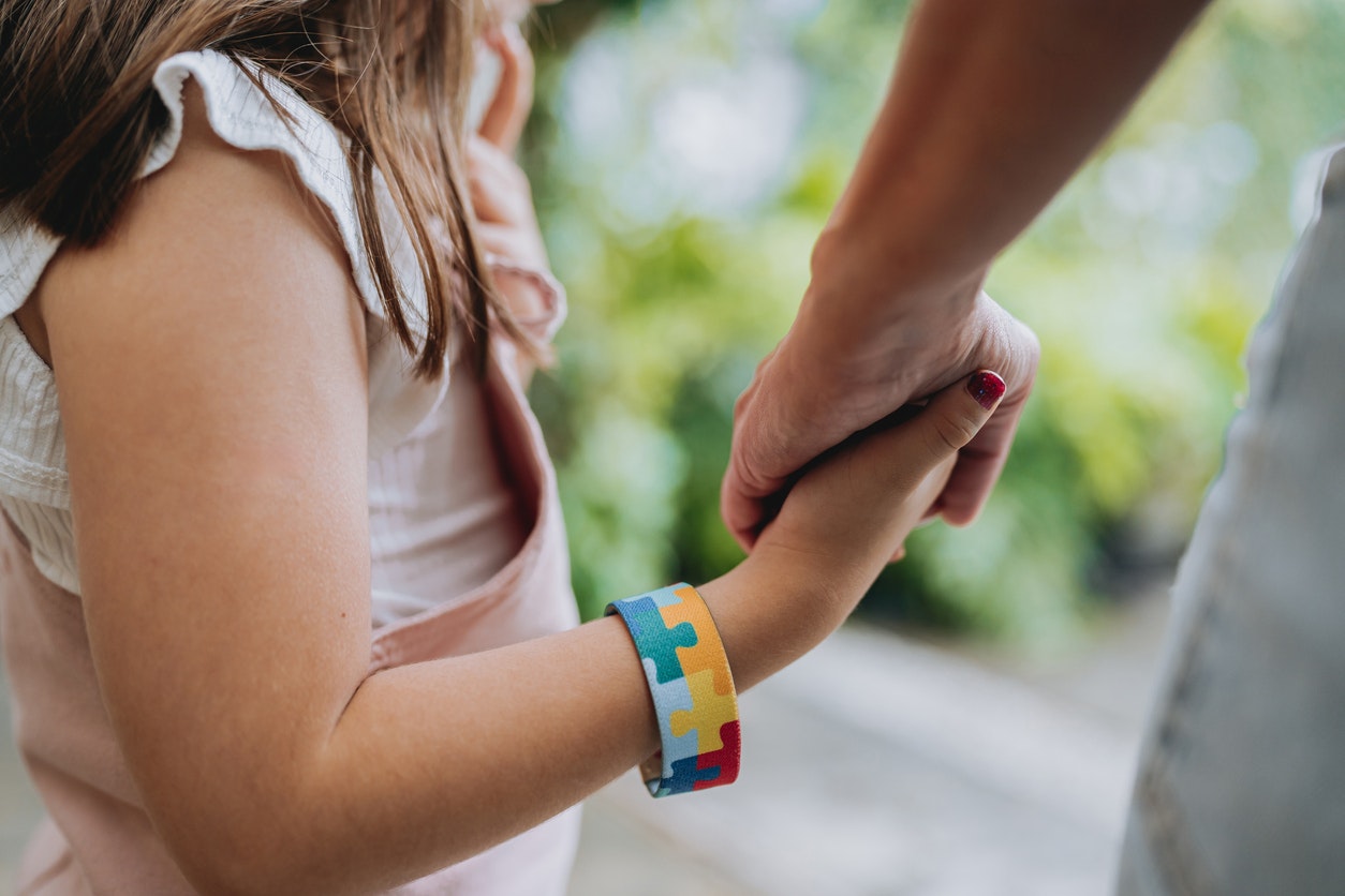 <p>Autistic child holding hands with her mother. [Source andreswd, iStock]</p>
