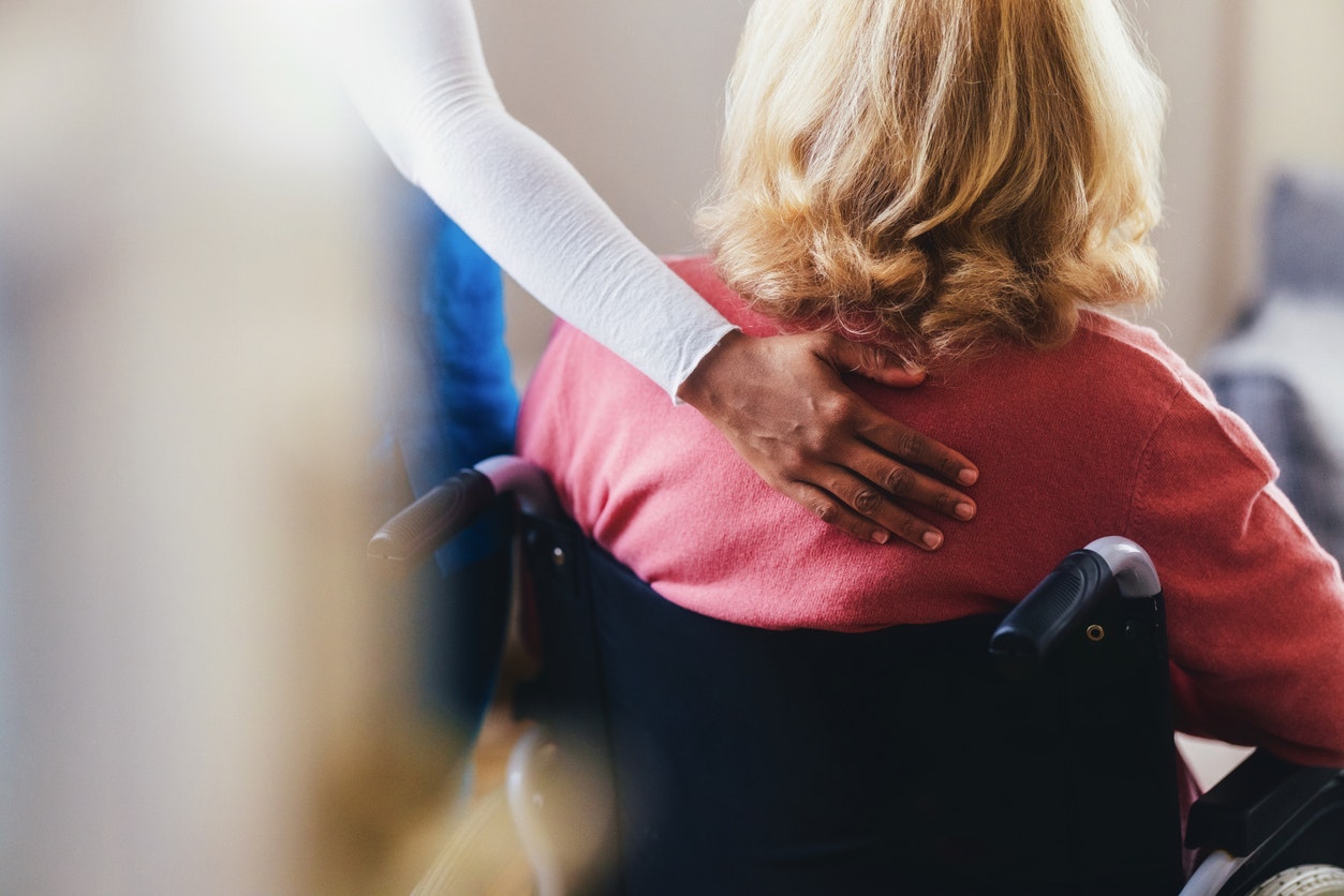 <p>A caregiver offering comfort and assistance to an elderly woman seated in a wheelchair. This touching moment captures care, empathy, and support often found in caregiving and medical contexts.</p>
