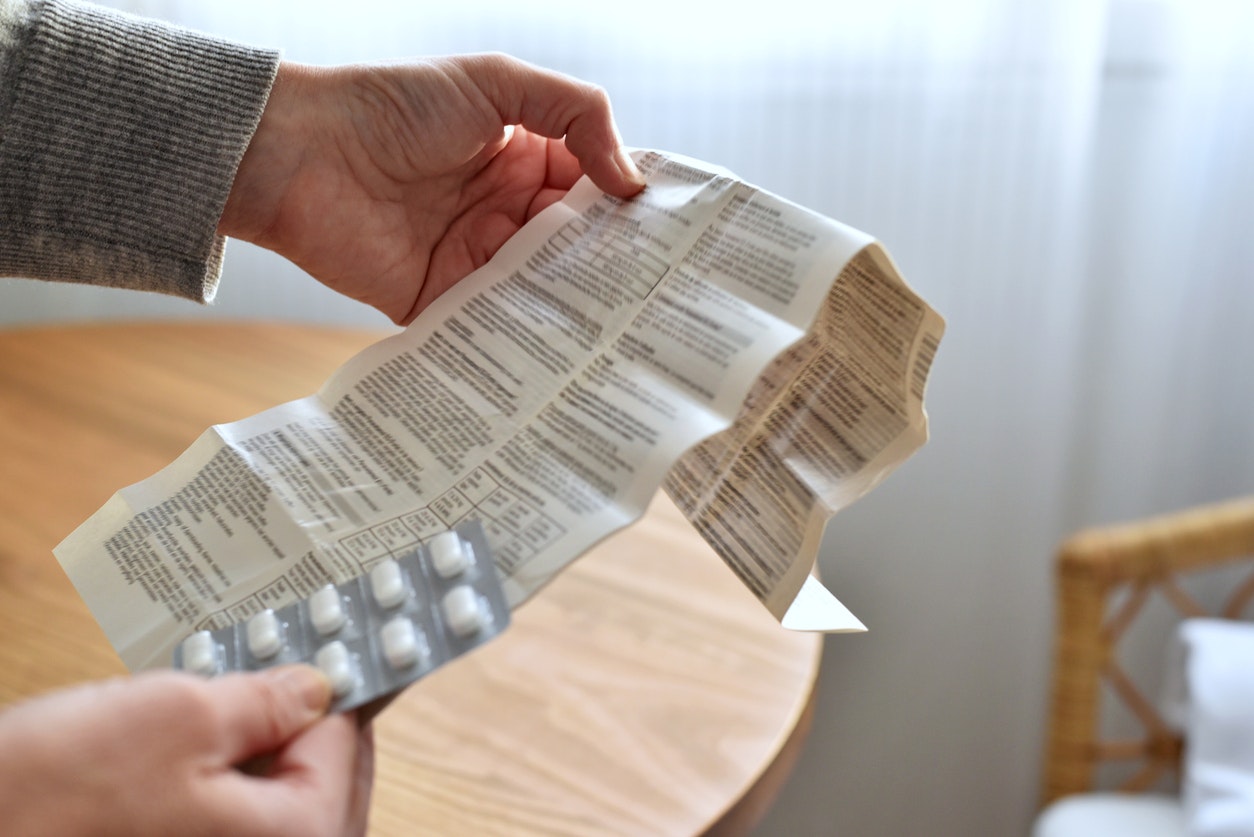 <p>Hands holding blister with pills and patient information leaflet</p>
