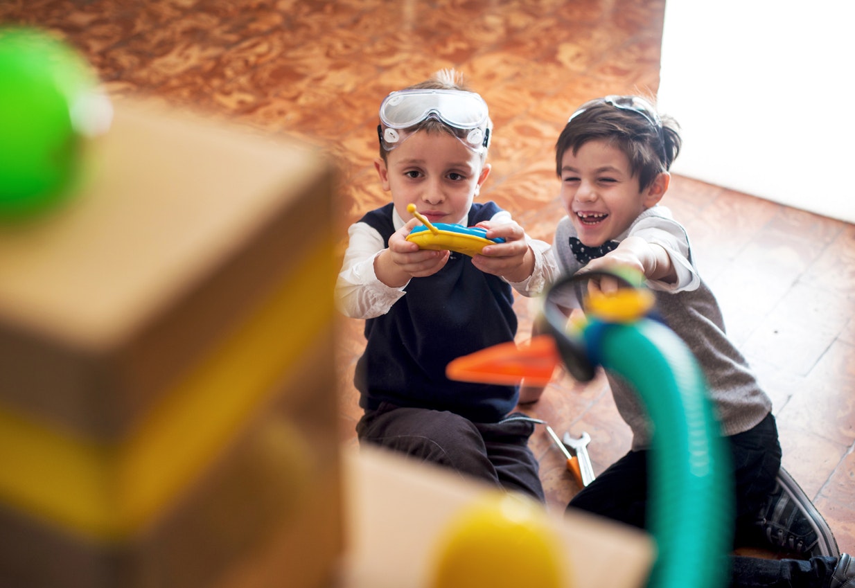 <p>Children Playing with Their Toy Robot</p>
