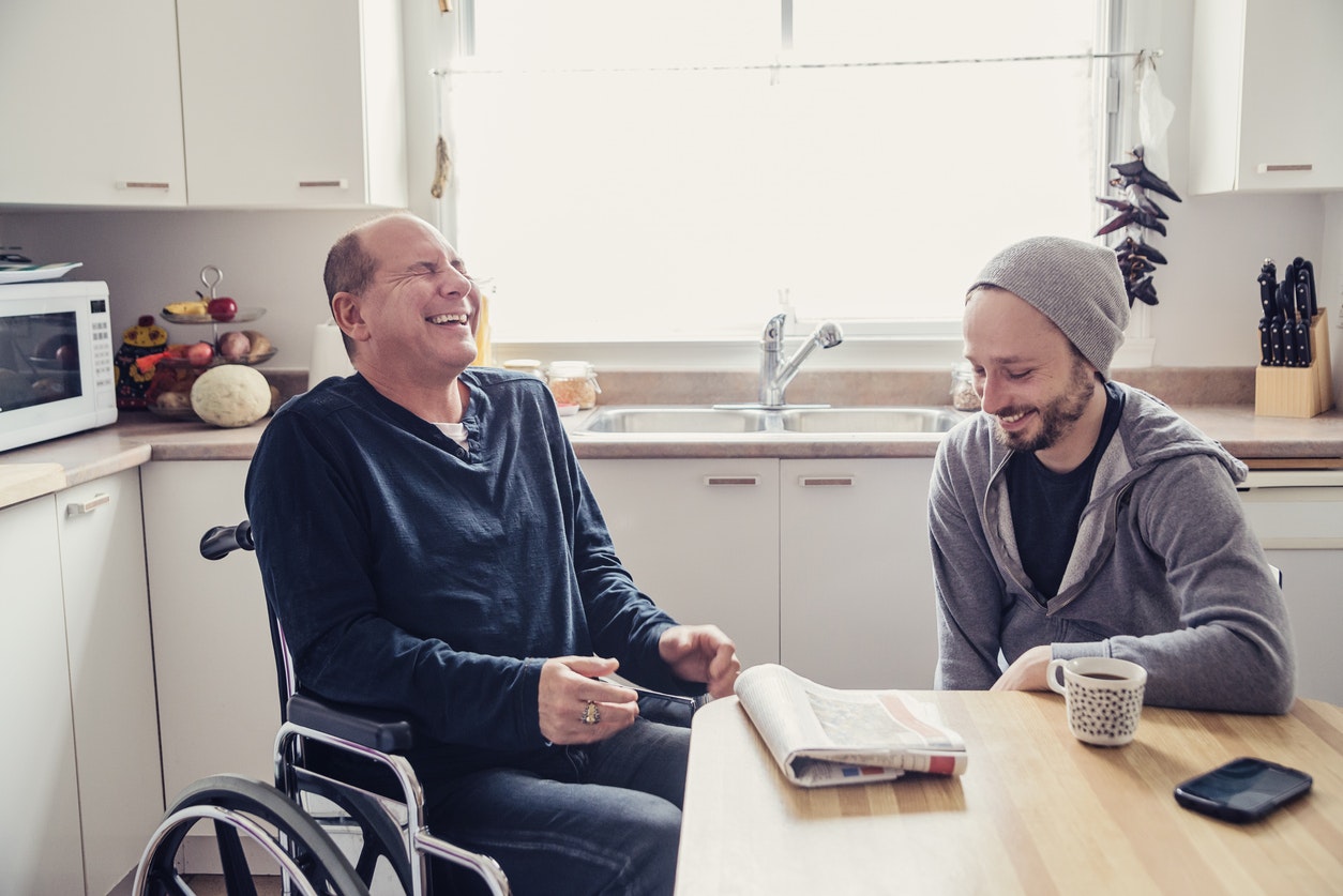 <p>Two man having a chat and a coffee in a home kitchen, talking about the morning paper. [Source martinedoucet, iStock]</p>
