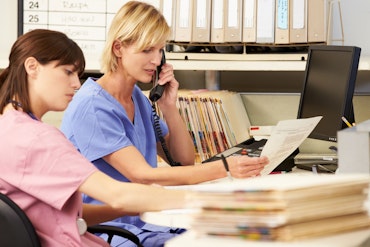 Nurses looking at paper
