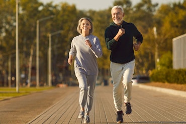 Two older people are running