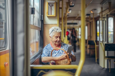 Older woman sits on bus