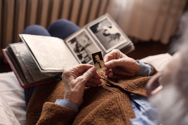 A person looks at a faded photo